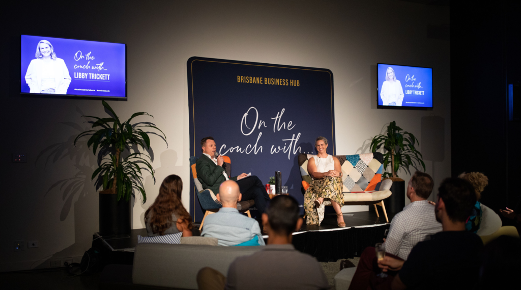 Libby Trickett on the couch with event photo